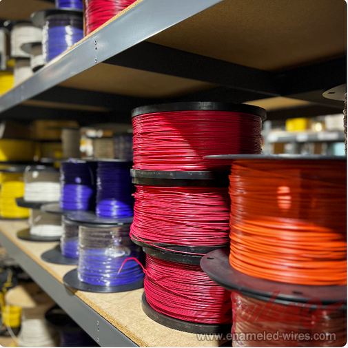 Colorful wire spools on a shelf.